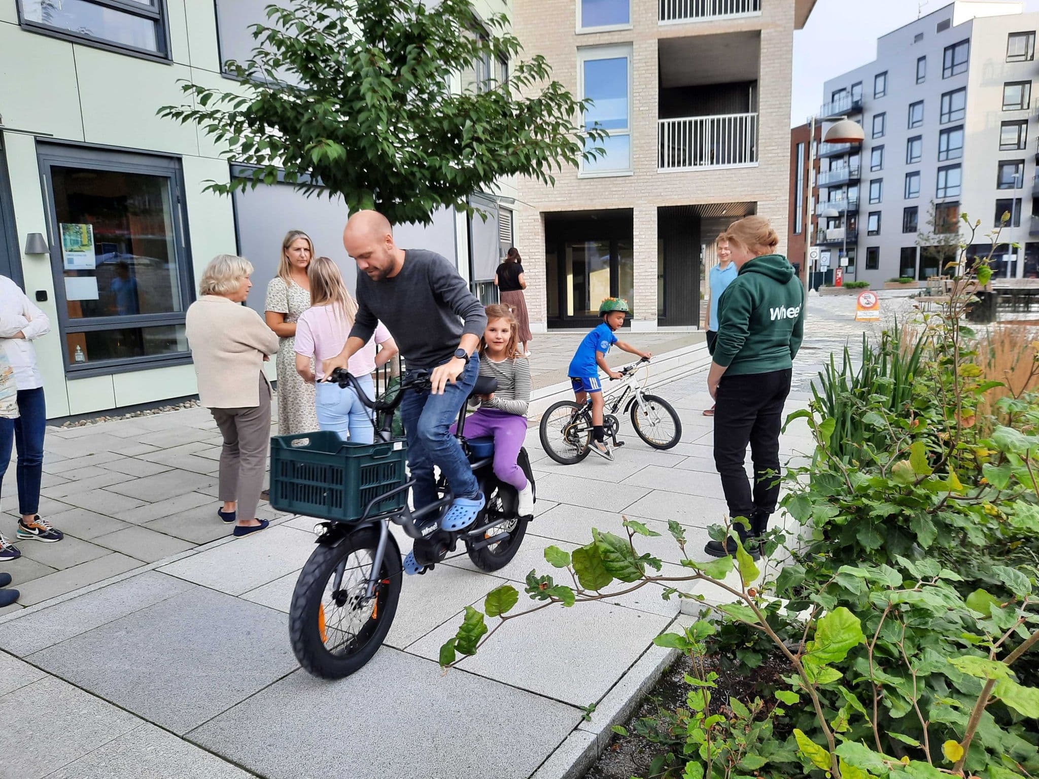Families trying out shared cargo bikes in a new development.